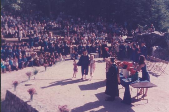 Susan Moren walking up with her two young daughters to receive her degree from UCSC, at the UCSC Quarry Amphitheater.